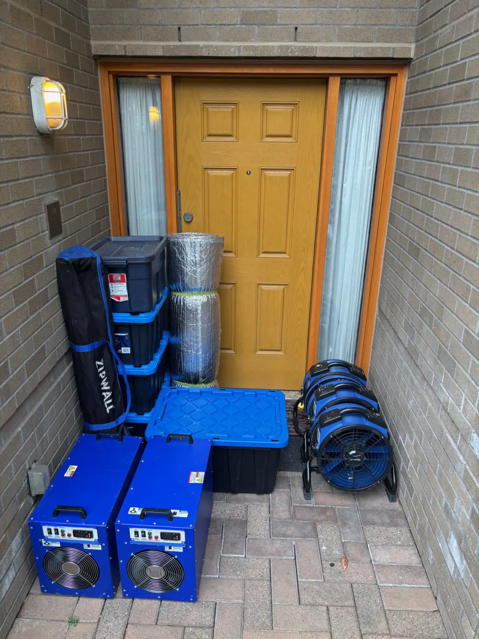 Heat Zone bed bug heater rental kit delivered to a customer's door: two heaters, fans, sealing poles and insulation