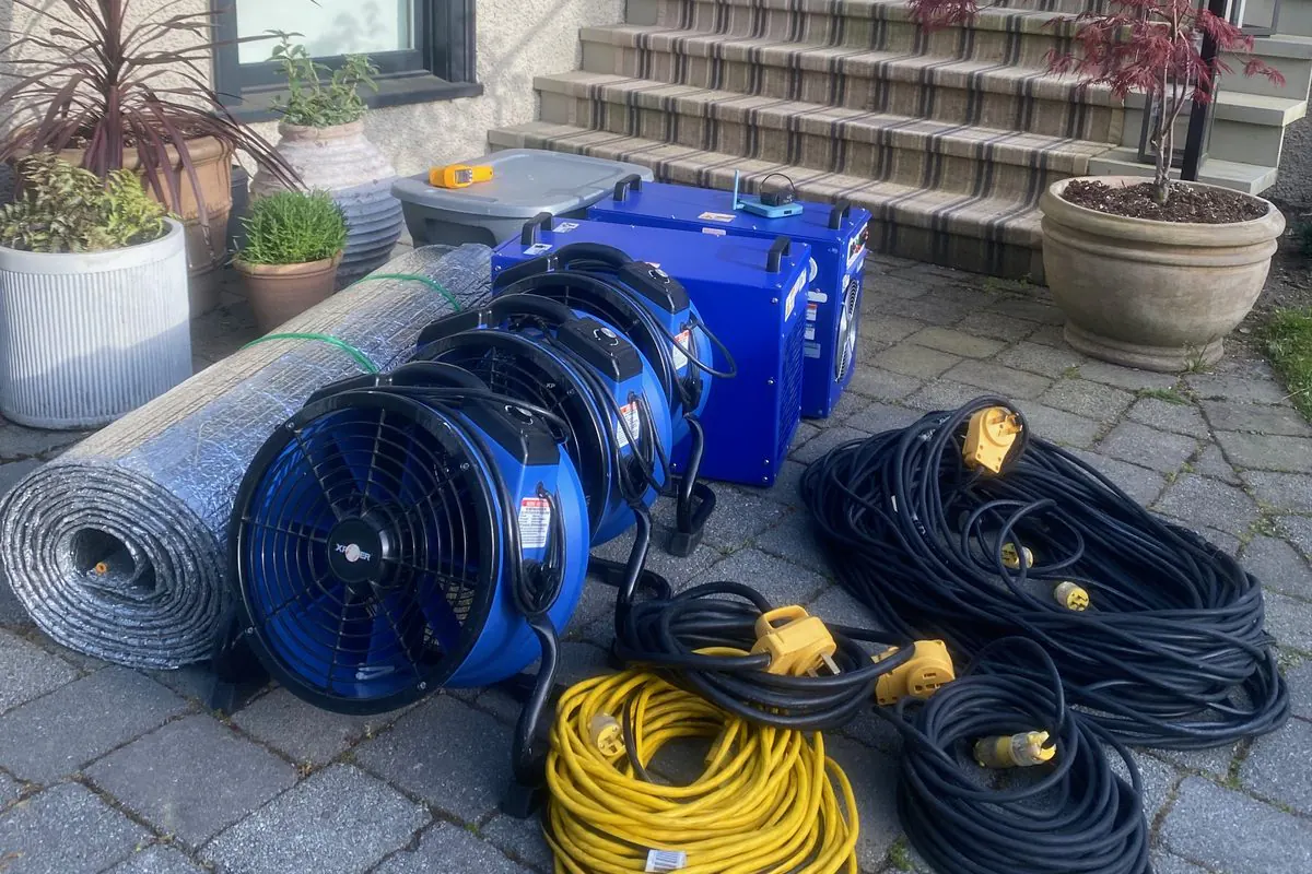 Heat Zone full-service bed bug heat treatment equipment set up outside a home: heaters, fans, insulation and power cords